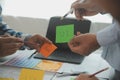 Close up ux developer and ui designer brainstorming about mobile app interface wireframe design on table with customer breif and Royalty Free Stock Photo