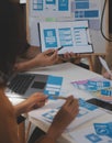 Close up ux developer and ui designer use augmented reality brainstorming about mobile app interface wireframe design on desk at Royalty Free Stock Photo