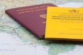 Close Up of Vaccination Certificate, Passport and world map.