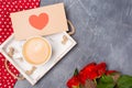 Close-up. Valentine`s Day concept. Morning coffee, envelope with heart, roses on grey desk. Free space. Space for text. Royalty Free Stock Photo