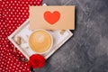 Close-up. Valentine`s Day concept. Morning coffee, envelope with heart, roses on grey desk. Free space. Space for text. Royalty Free Stock Photo