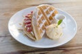 Close up of vanilla ice cream with waffle and fresh strawberry on wood table background Royalty Free Stock Photo