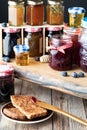 Close up of a variety of different types of jam in jars and honey with toast in front. Royalty Free Stock Photo