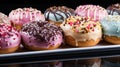 Close-up of variety of glazed delicious festive donuts with colourful sprinkles. Generative AI