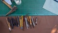 Close-up variety tools available trim leather for craft work, made by myself with all these hands equipment,