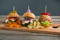 Close up of various burgers on cutting board Royalty Free Stock Photo