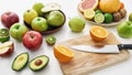 Close up of various colorful fresh summer fruits, Sliced fruits and a knife on cutting board isolated over white Royalty Free Stock Photo