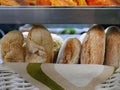 Close up various of fresh baked goods, bakery, long shape breads, pastry stack in white wicker basket ready to sell in Bakery Royalty Free Stock Photo