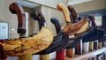 Close up of various keris or traditional indonesian weapon handles and scabbards with unique wood carvings