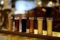 Various kinds of beer in pint glasses on table in bar. Royalty Free Stock Photo