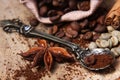 Close-up various kinds of coffee beans, green coffee, anise star, scattered on a wooden background, ground coffee spoon on vintage