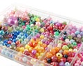 close-up various sizes and shaped colorful beads in transparent plastic tray Royalty Free Stock Photo