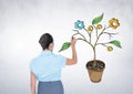 Woman holding pen and Drawing of Business graphics on plant branches on wall Royalty Free Stock Photo