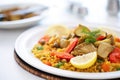 close-up of vegan paella with artichokes and beans on white plate Royalty Free Stock Photo