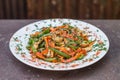 Close-up of vegetable wok with chicken. Selective focus on a healthy food with red and green bell peppers, carrots, soy sauce. Royalty Free Stock Photo