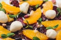 Close-up vegetables, fruits, cheese mixed in a salad