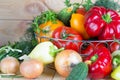 Close up vegetables harvest in wicker basket on wooden background. Raw foods. Royalty Free Stock Photo