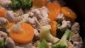 Close up of vegetables in a pan being prepared with white chicken meat. Concept. Cooking tasty dinner of carrots Royalty Free Stock Photo