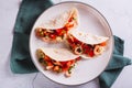 Close up of vegetarian mini tacos with tomatoes, shrimp and herbs on a plate top view