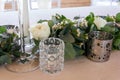 Close up veiw of wedding floral details. White candles,roses and eucalyptus.