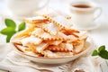 Close-up of verguny cookies or Faworki. Chiacchiere with a dusting of powdered sugar, served beside a cup of tea for a festive