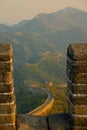 CLOSE UP: Monumental stone wall crosses the forest covered mountains in China.