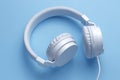 Close-up vertical image of white headphone on blue background. Music concept.