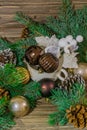 Vertical photo of spruce tree branches, christmas toys, pine cones and white cup on a wooden background Royalty Free Stock Photo