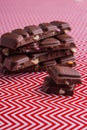 Close-up vertical shot chocolate bars on red and white background.