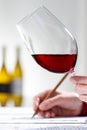 Vertical shot of sommelier evaluating red wine at table Royalty Free Stock Photo