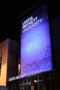 Close up vertical shot of Leeds Beckett University lite up