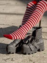 Close up Vertical shot Red and white striped stockings feet and heel boots. Goth emo rebel girl teen concept Royalty Free Stock Photo