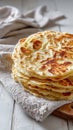 Stack of Golden Brown Pan Fried Flatbreads Dusted With Powdered Sugar on a Rustic Table Royalty Free Stock Photo