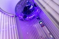 Close up of vertical solarium for tanning skin in spa salon, ultraviolet rays color