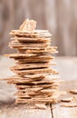 Close-up vertical stack of corn crispbreads on wooden background.