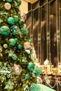 Close up vertical view of decorated Christmas tree on blurred background in midnight green theme / New Year Holidays/ bokeh effect Royalty Free Stock Photo