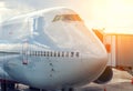 Close-up of very large wide-body airplane being prepared for towing, with tow-truck connected. Royalty Free Stock Photo