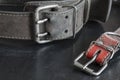 Close-up of very old genuine leather collars on a dark table