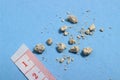 Flat lay or top view very small kidney stones with ruler at blue background Royalty Free Stock Photo