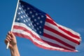 A close-up of a veteran\'s hand holding an American flag.