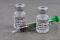 Close up of vials of vaccines to fight coronavirus with syringe