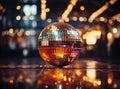 Close-up of a vibrant disco ball reflecting colorful lights in a dimly lit room, creating a lively party atmosphere.