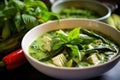 close-up of vibrant green thai green curry in a white bowl