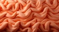 A close up of a vibrant peach fabric texture