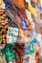 Close up of a vibrant quilted fabric with patchwork of diverse patterns and textures, creating a colorful abstract