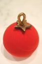 Close Up of Vibrant Red Velvet Christmas Ball Ornament Shaped Cake with Berry Mousse Inside