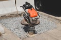Close-up of a vibrating rammer on the road Royalty Free Stock Photo