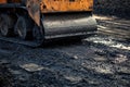 Vibratory roller compacting fresh hot asphalt on a road construction site Royalty Free Stock Photo