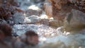 Close-up video of the purest transparent water in a mountain river flowing among the stones.