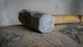 Close up view of abandon big steel hammer at construction site on cement bag